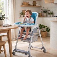 Thumbnail for Toddler eating at the table in the blue Ingenuity high chair