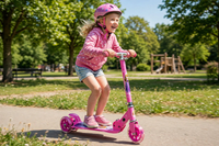 Thumbnail for Kid riding the Barbie metal scooter in a park
