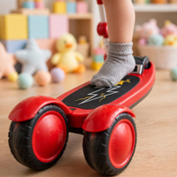 Thumbnail for Close-up of deck and wheels of the red 3-in-1 toddler scooter